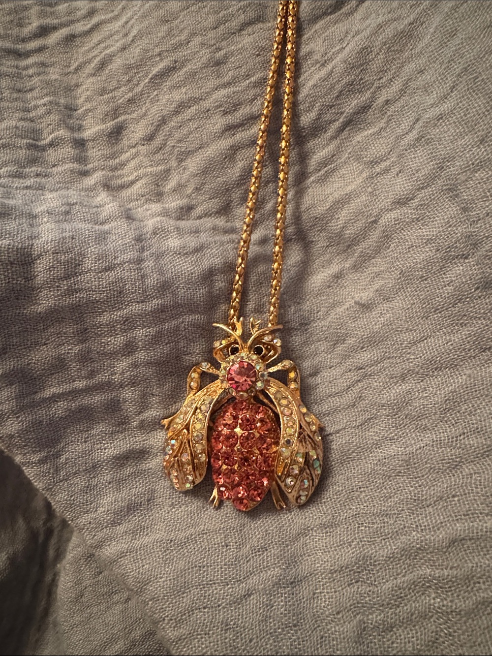 Betsey Johnson 27” pink crystal bug with gold tone wings and crystals.